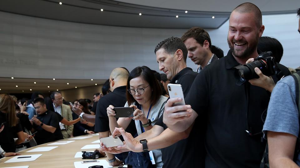 An attendee looks at a new iPhone X during an Apple special event at the Steve Jobs Theatre on the Apple Park campus on September 12 in Cupertino, California.