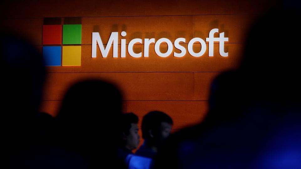 The Microsoft logo illuminated on a wall during a Microsoft launch event in New York City.