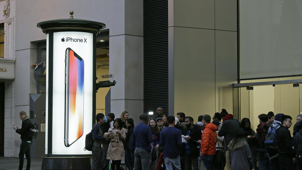People stand in line outside the Apple Union Square store to purchase the new iPhone X on November 3, 2017, in San Francisco.