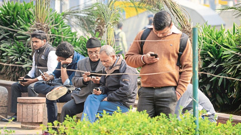 people using smart phones , in a busy area in central Delhi connaught place , photographed on 12 Feb 2016 by Ramesh Pathania/ Mint
