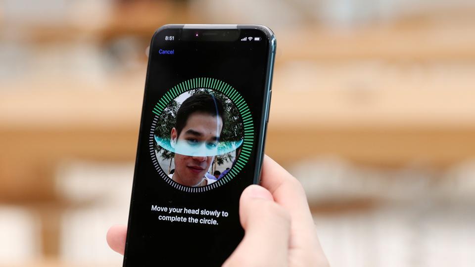 A customer sets up his iPhone X Face ID during its launch at the Apple store in Singapore November 3, 2017.
