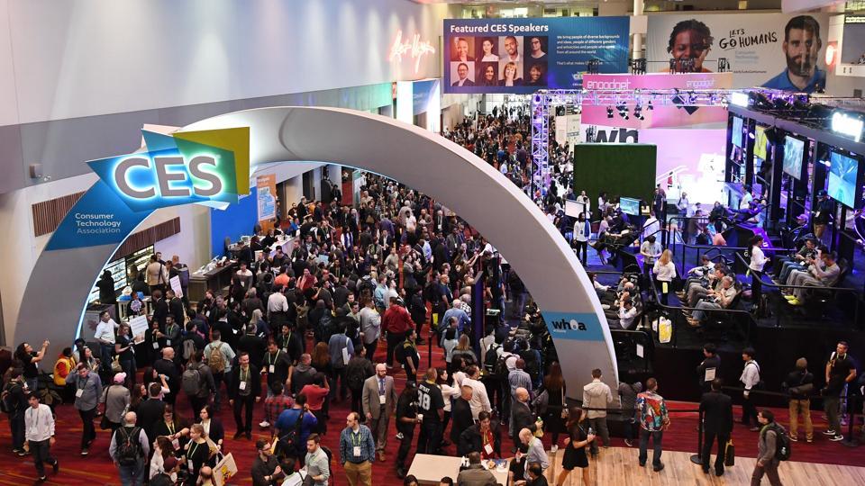 Attendees walk under a CES sign in the lobby during CES 2018 at the Las Vegas Convention Center on January 11, 2018 in Las Vegas, Nevada.