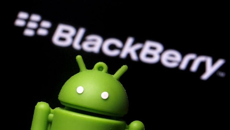 An Android mascot is seen in front of a logo of Blackberry in this photo illustration taken in Zenica.