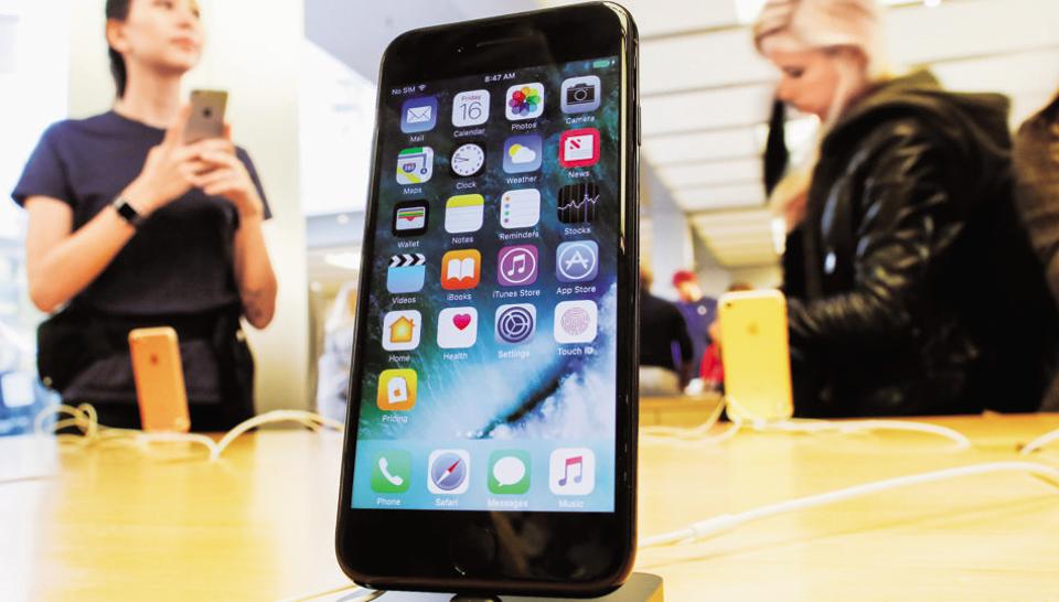 Customers take a look at the new iPhone 7 smartphone inside of an Apple Inc. store in New York, U.S.