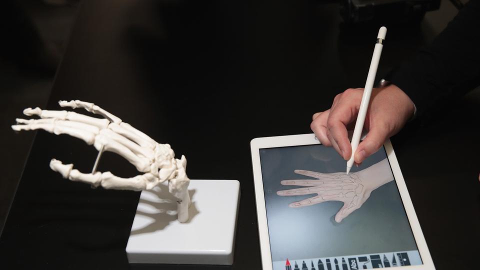 A guest draws the bones of the hand on Apple's new 9.7-inch iPad during an event held to introduce the device at Lane Tech College Prep High School on March 27, 2018 in Chicago, Illinois.