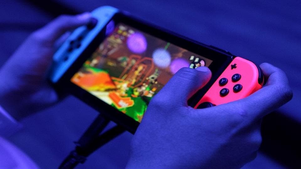 An attendee plays on a Nintendo Switch during the E3 Electronic Entertainment Expo in Los Angeles.