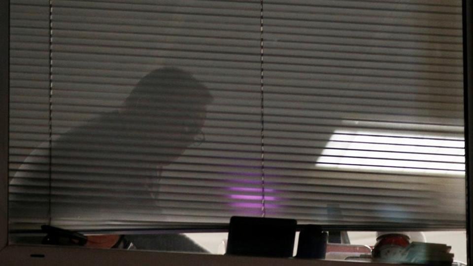 A person is seen inside the building which houses the offices of Cambridge Analytica.