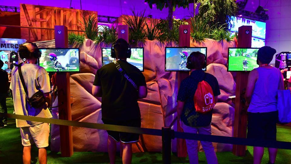 Gaming fans play the game 'Fortnite' at the 24th Electronic Expo, or E3 2018 in Los Angeles, California.