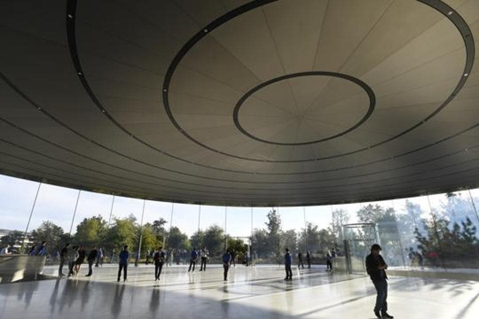 Employees stand among attendees ahead of an Apple Inc. event at the Steve Jobs Theater in Cupertino, California, US, on Wednesday, September 12, 2018. Employees stand among attendees ahead of an Apple Inc. event at the Steve Jobs Theater in Cupertino, California, US, on Wednesday, September 12, 2018.