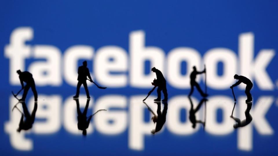 Figurines are seen in front of the Facebook logo in this illustration taken March 20, 2018.