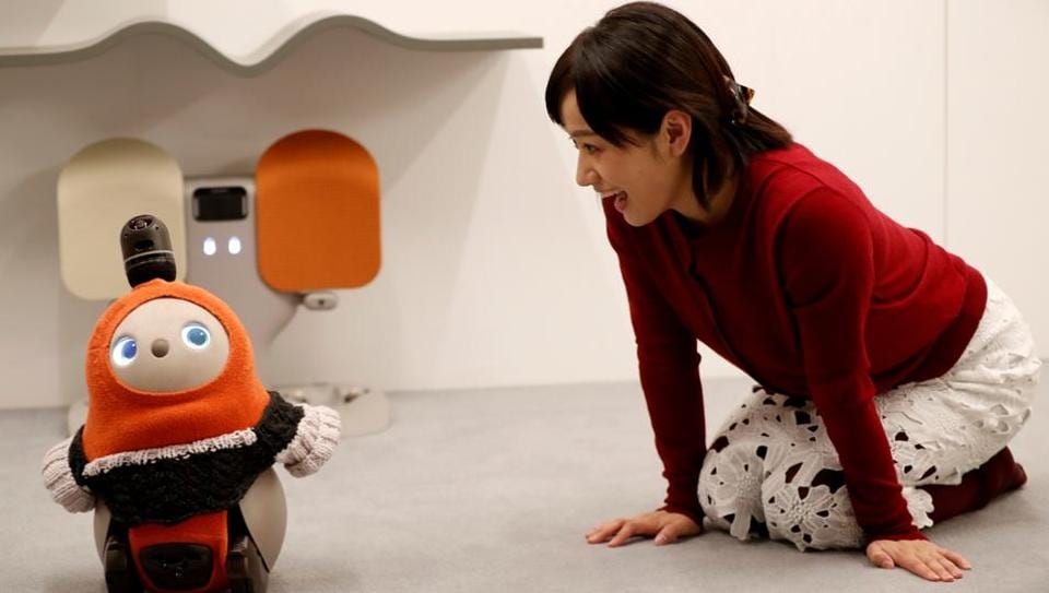 A woman calls up GROOVE X's new home robot LOVOT at its demonstration during the launching event in Tokyo, Japan, December 18, 2018.