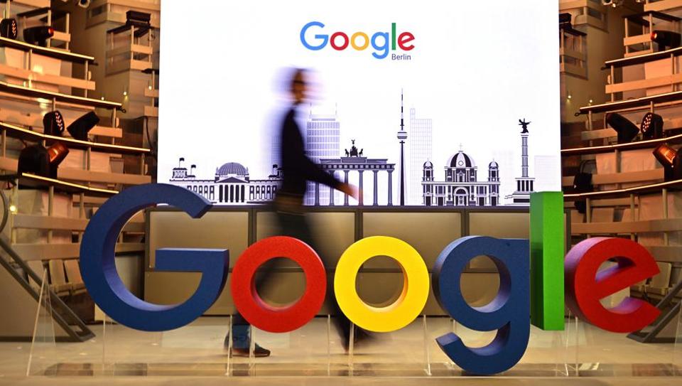 A technician passes by a logo of US internet search giant Google during the opening day of a new Berlin office of Google in Berlin on January 22, 2019.