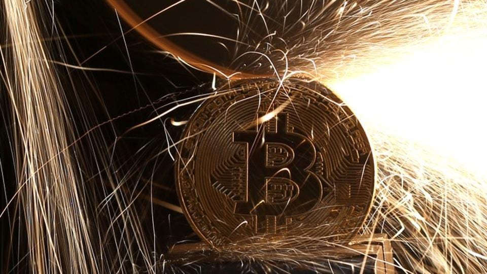 Sparks glow from broken Bitcoin (virtual currency) coins in this illustration picture, December 8, 2017. Picture taken December 8. REUTERS/Dado Ruvic/Illustration