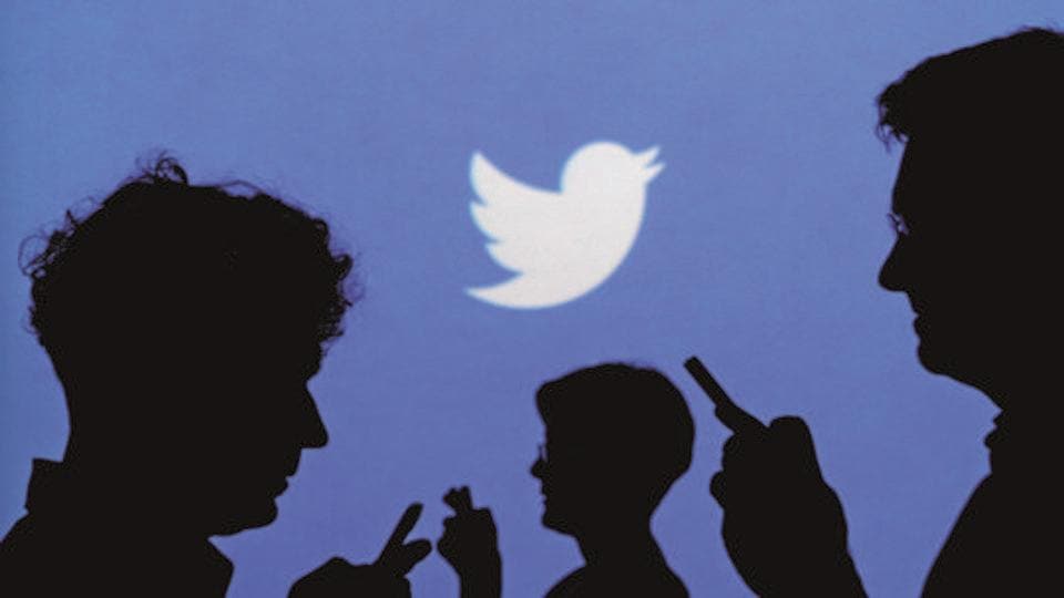 People holding mobile phones are silhouetted against a backdrop projected with the Twitter logo in this illustration picture taken in Warsaw September 27, 2013. REUTERS/Kacper Pempel/Illustration/File Photo GLOBAL BUSINESS WEEK AHEAD PACKAGE - SEARCH 