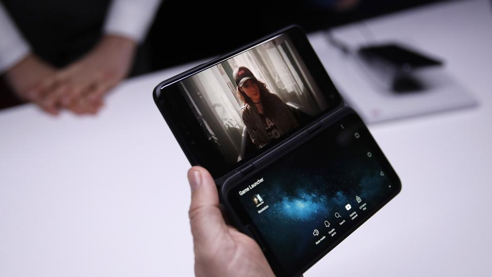 An attendee inspects a V50 ThinQ 5G smartphone with a dual screen accessory during an LG Electronics Inc. launch event ahead of the MWC Barcelona in Barcelona.