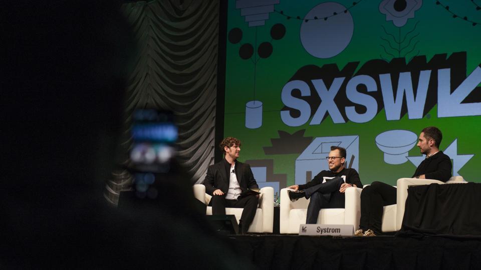 Mike Krieger, center, and Kevin Systrom, co-founders of Instagram, right, speak with Josh Constine, of TechCrunch, during a panel discussion at the South By Southwest (SXSW) conference in Austin.