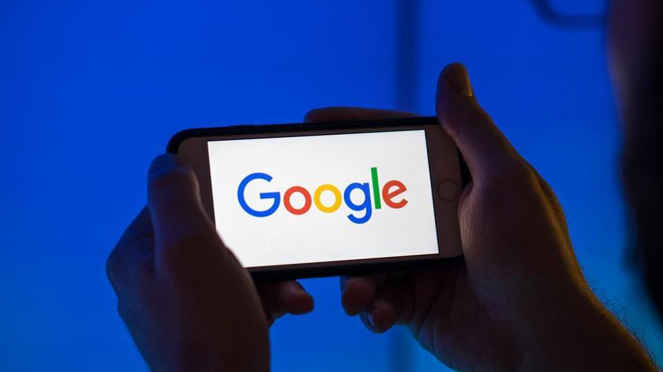 The logo of Google, a unit of Alphabet Inc., sits on an Apple Inc. iPhone smartphone in this arranged photograph in London, U.K., on Monday, Aug. 20, 2018. The NYSE FANG+ Index is an equal-dollar weighted index designed to represent a segment of the technology and consumer discretionary sectors consisting of highly-traded growth stocks of technology and tech-enabled companies. Photographer: Jason Alden/Bloomberg