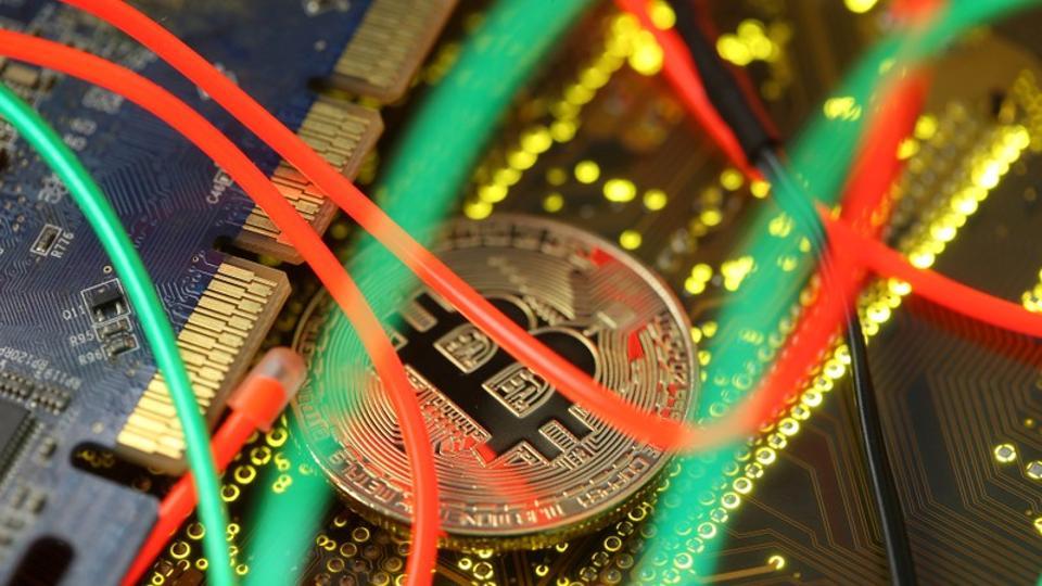 FILE PHOTO: Representation of the Bitcoin virtual currency standing on a PC motherboard is seen in this illustration picture, February 3, 2018. REUTERS/Dado Ruvic/Illustration/File Photo