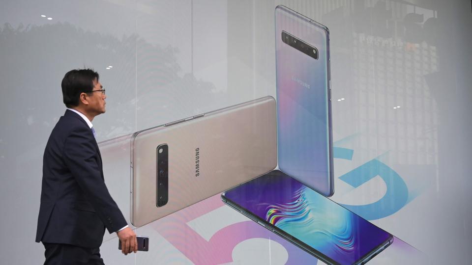 A pedestrian walks past an advertisement for the Samsung Galaxy S10 5G smartphone in Seoul on April 30, 2019.