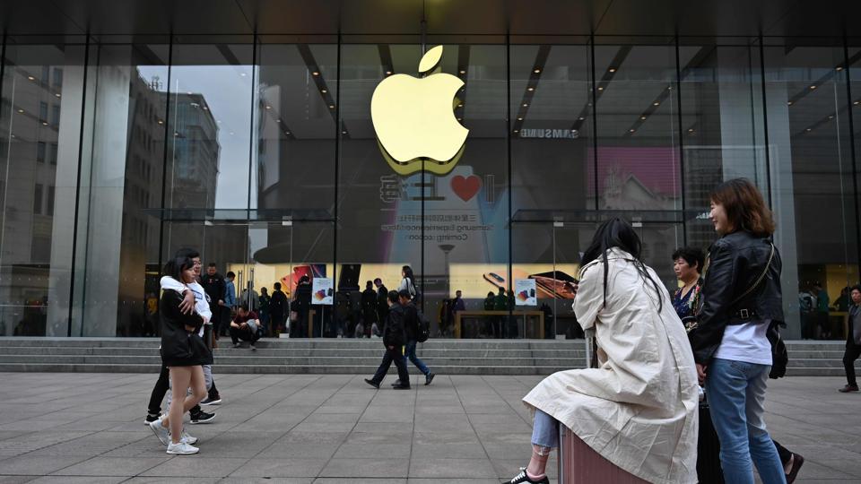 People walk past the front of an Apple store in central Shanghai on May 8, 2019.