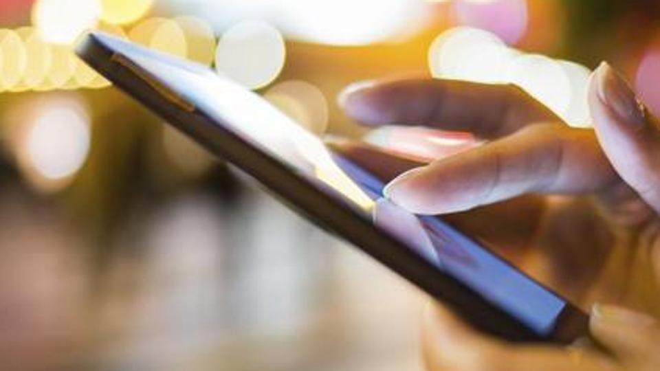 Woman using her Mobile Phone, Night Light Background Woman using her Mobile Phone, Night Light Background