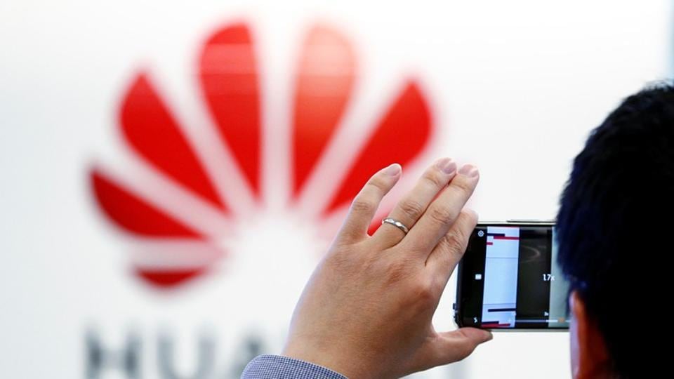 A man takes a picture of a Huawei logo at the Huawei European Cybersecurity Center in Brussels, Belgium, May 21, 2019. REUTERS/Francois Lenoir