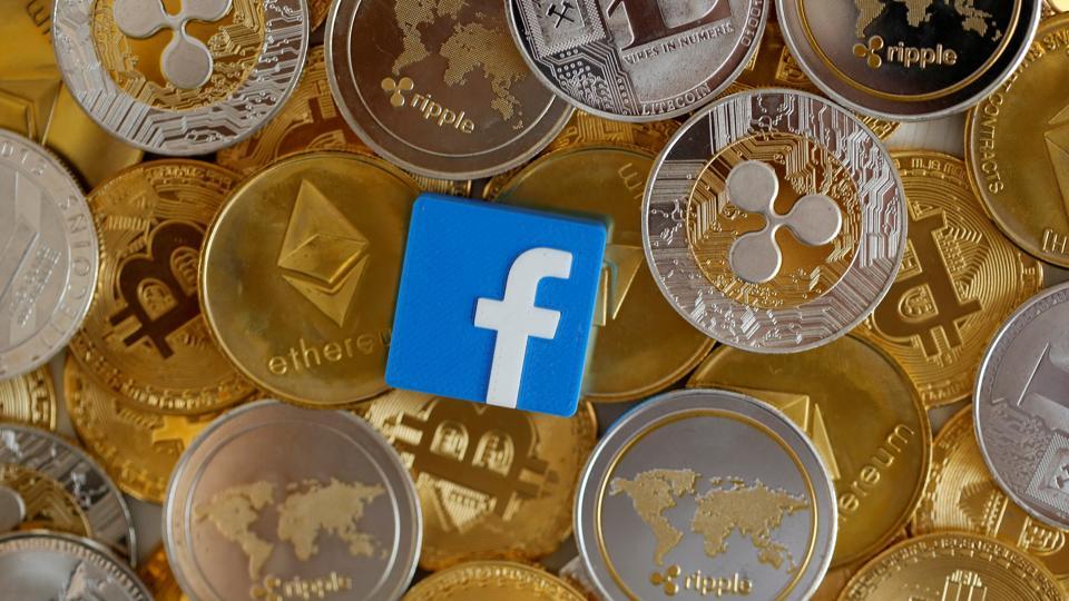 A 3-D printed Facebook logo is seen on representations of virtual currencies in this illustration picture, June 18, 2019.