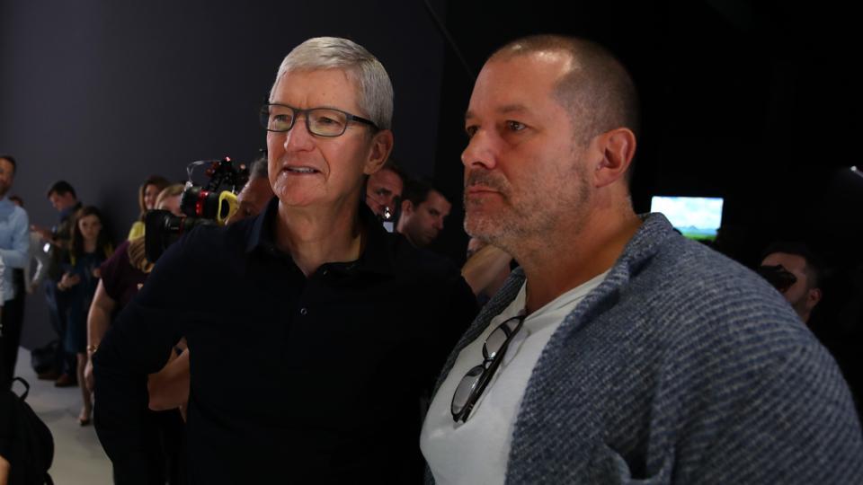 (FILES) In this file photo taken on June 3, 2019 Apple CEO Tim Cook (L) and Apple chief design officer Jony Ive (R) look at the new Mac Pro during the 2019 Apple Worldwide Developer Conference (WWDC)