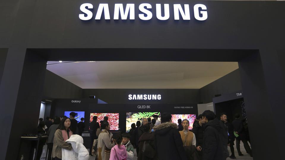 FILE - In this Jan. 30, 2019, file photo, visitors enter Samsung Electronics' booth during an industrial fair in Seoul, South Korea. Samsung Electronics Co. on Friday, July 5, 2019, says its operating profit for the last quarter likely fell more than 56% from a year earlier amid a weak market for memory chips. (AP Photo/Ahn Young-joon, File)