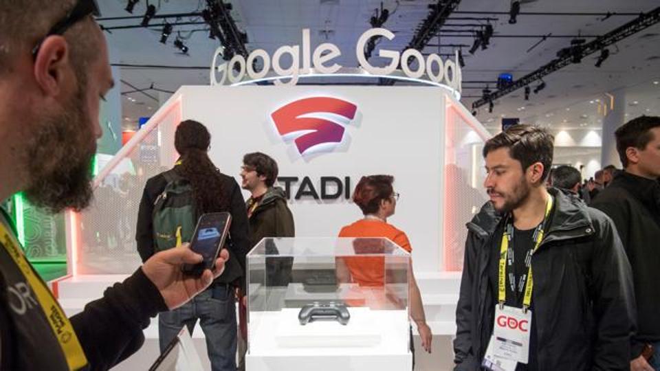 Attendees look at the Google Inc. Stadia game controller at the Game Developers Conference in San Francisco, California, U.S., on Wednesday, March 20, 2019. The annual event brings together over 28,000 industry leaders and game developers to exchange ideas and shape the future of the gaming industry. Photographer: David Paul Morris/Bloomberg