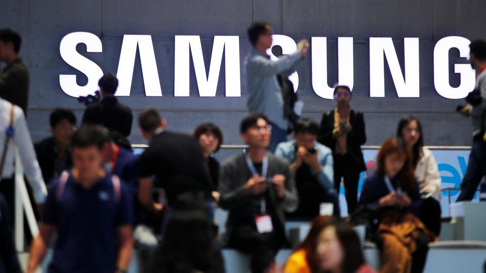 People sit in front of a Samsung logo at the IFA consumer tech fair in Berlin, Germany, September 6, 2019.