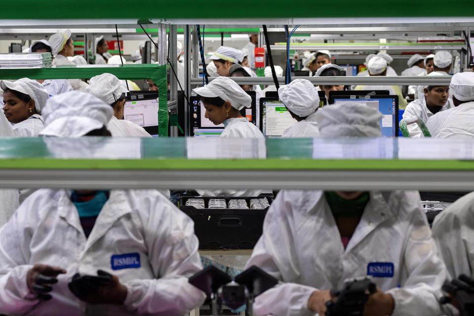 Employees test mobile phones on an assembly line in the mobile phone plant of Rising Stars Mobile India Pvt., a unit of Foxconn Technology Co., in Sriperumbudur, Tamil Nadu, India, on Friday, July 12, 2019. Foxconn, also known as Hon Hai Precision Industry Co., opened its first India factory four years ago, it now operates two assembly plants with plans to expand those and open two more. The company was integral to China’s transformation into a manufacturing colossus, and founder Terry Gou has told India's Prime Minister Narendra Modi that Foxconn could help India do the same.