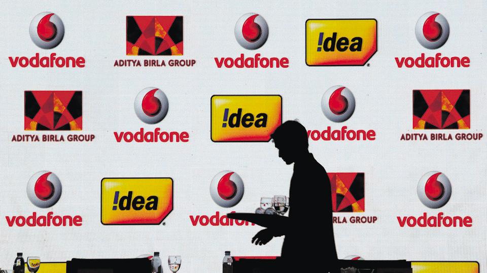 FILE PHOTO: A hotel employee clears a table after Vodafone Group and Idea Cellular news conference in Mumbai, India March 20, 2017. REUTERS/Danish Siddiqui/File Photo