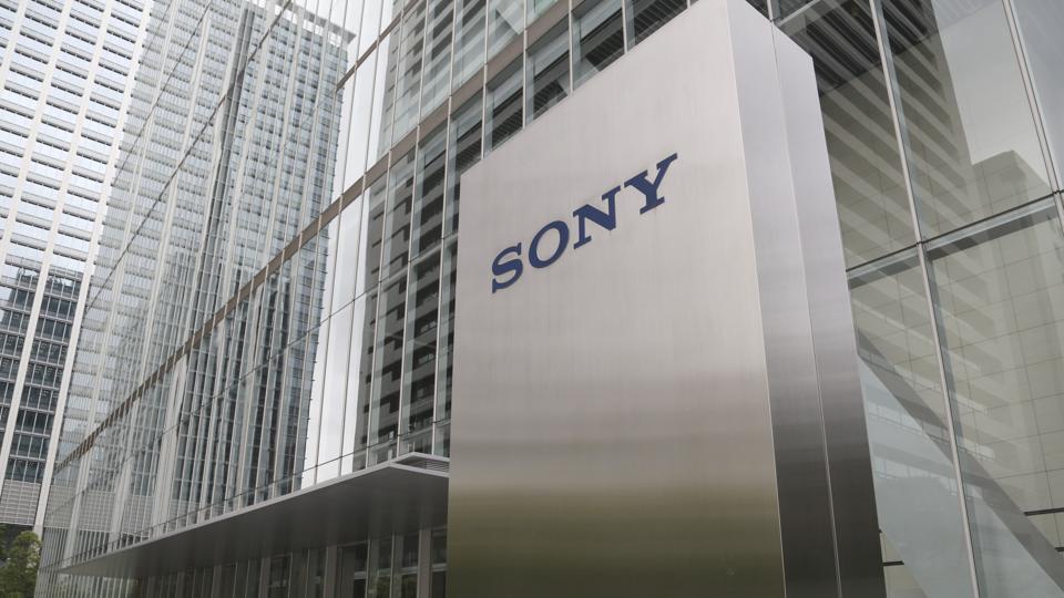 In this July 19, 2019, photo, people walk out from the headquarters of Sony Corp., in Tokyo. Sony Corp. says its net profit fell 15% in the first half of the year, though strong sales of entertainment and imaging sensors offset weakness in the games sector. The company said Wednesday, Oct. 30, that its sales dipped 2% from a year earlier in April-September, to 4 trillion yen ($37.2 billion).
