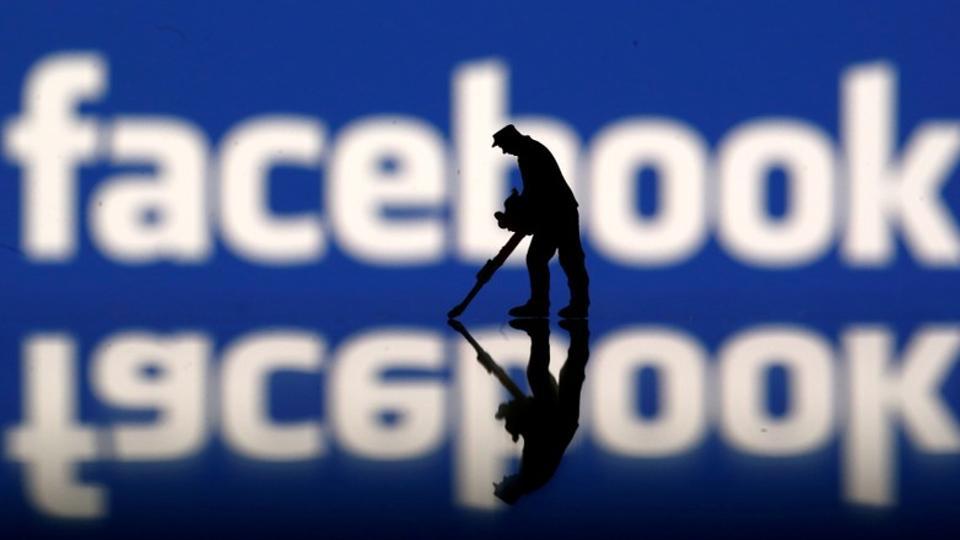 FILE PHOTO: A figurine is seen in front of the Facebook logo in this illustration taken March 20, 2018. REUTERS/Dado Ruvic
