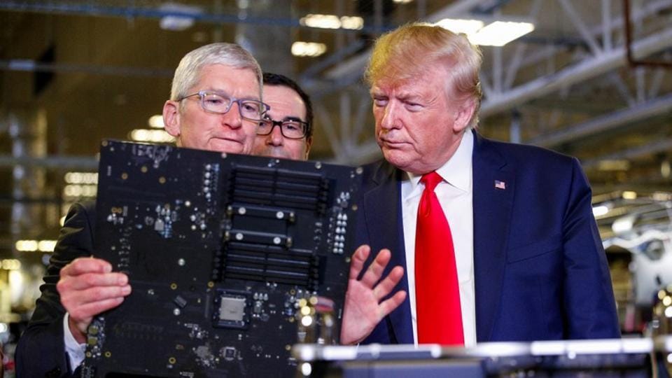 Apple CEO Tim Cook escorts US President Donald Trump as he tours Apple's Mac Pro manufacturing plant