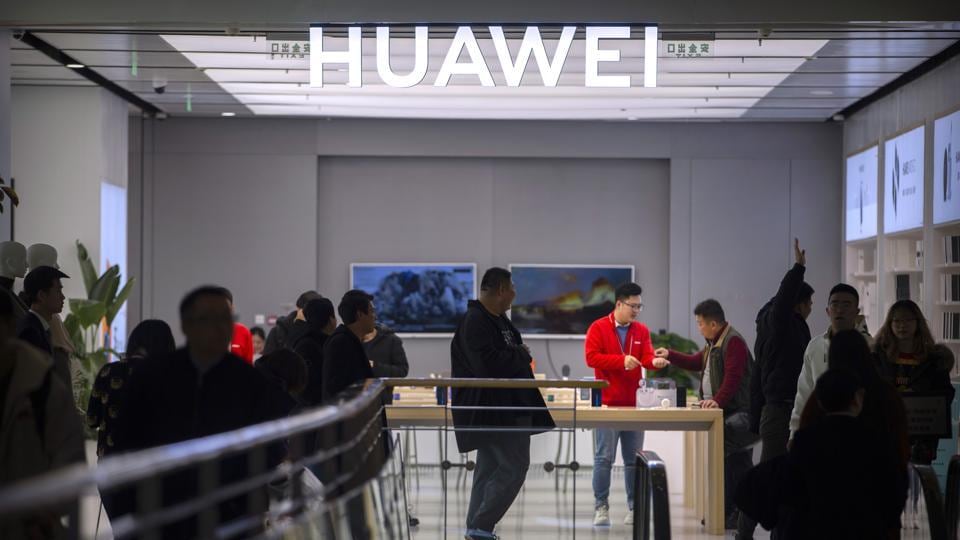 In this Nov. 20, 2019, photo, customers shop at a Huawei store at a shopping mall in Beijing. The founder of Huawei says the Chinese tech giant is moving its U.S. research center to Canada due to American restrictions on its activities.