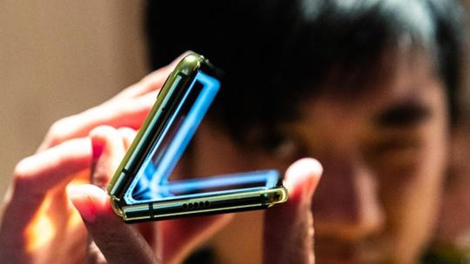 It looks like the phone is opens up to look like a standard bar phone with the volume rocker on the right. There is a punch-hole display for the front camera and no colour display on the outside.. Photographer: Jeenah Moon/Bloomberg