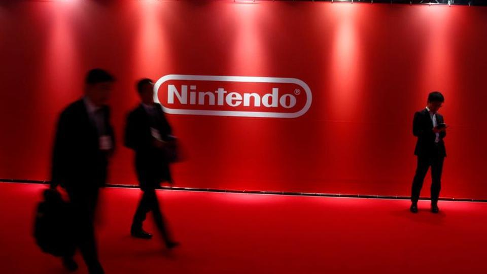 People stand in front of Nintendo's logo at the presentation ceremony of its new game console Switch in Tokyo, Japan January 13, 2017.