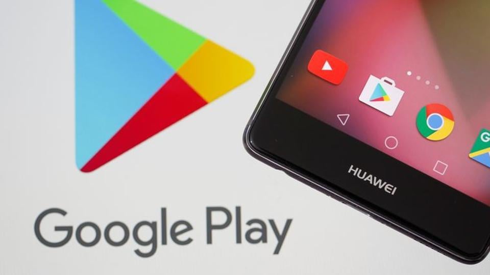 A Huawei smartphone is seen in front of displayed Google Play logo