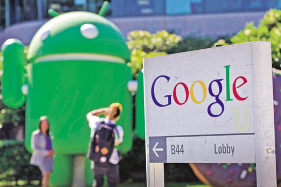 Pedestrians take photographs in front of a Google Inc., office building at the company's headquarters in Mountain View, California, U.S., on Friday, Sept. 27, 2013. Google is celebrating it's 15th anniversary as the company reaches $290 billion market value. Photographer: David Paul Morris/Bloomberg