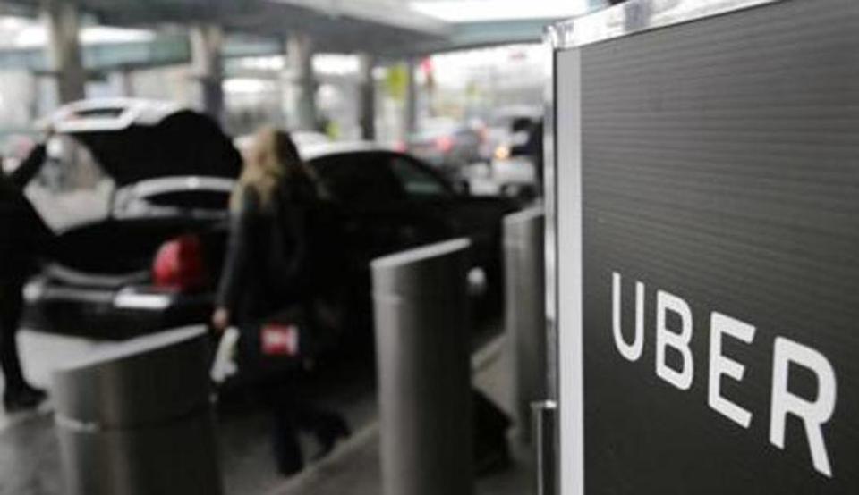 FILE - In this March 15, 2017, file photo, a sign marks a pick up point for the Uber car service at LaGuardia Airport in New York. Ride-hailing giant Uber has filed confidential preliminary paperwork for selling stock to the public. That's according to a report late Friday, Dec. 7, 2018 in the Wall Street Journal. (AP Photo/Seth Wenig, File)