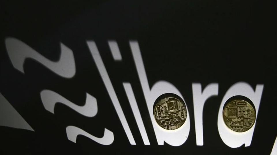 Shadow of a 3D-printed Facebook Libra cryptocurrency logo is seen near cryptocurrency representation in this illustration taken, September 13, 2019.