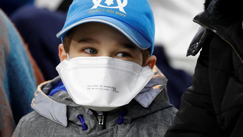 Olympique de Marseille fan wearing a face mask amid concerns following the coronavirus outbreak.