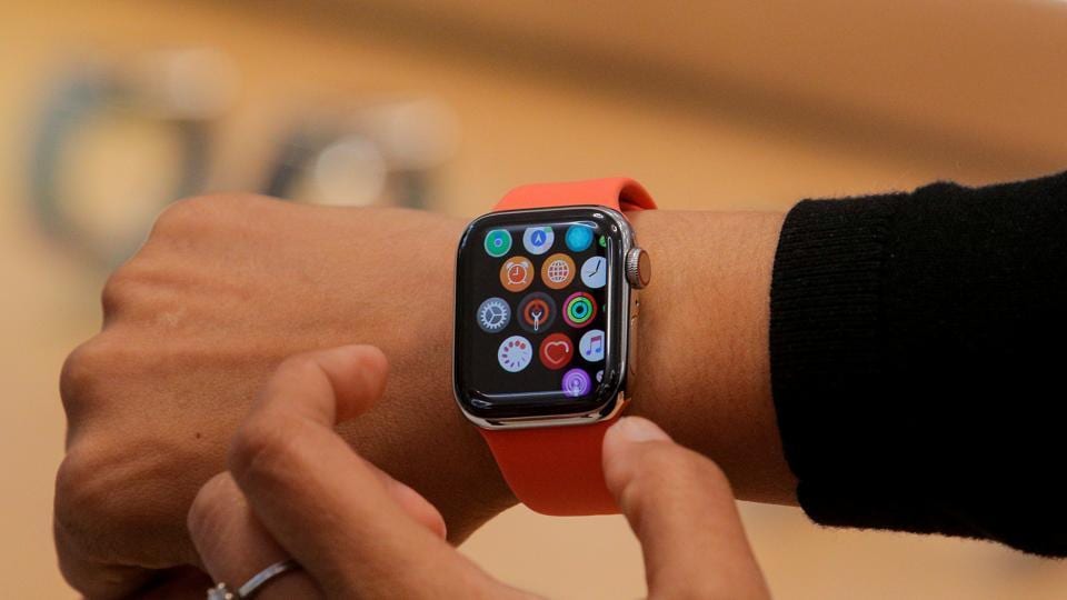 FILE PHOTO: An Apple Store employee shows the new Series 5 Apple Watch during the preview of the redesigned and reimagined Apple Fifth Avenue store in New York, US, September 19, 2019. REUTERS/Brendan McDermid/File Photo