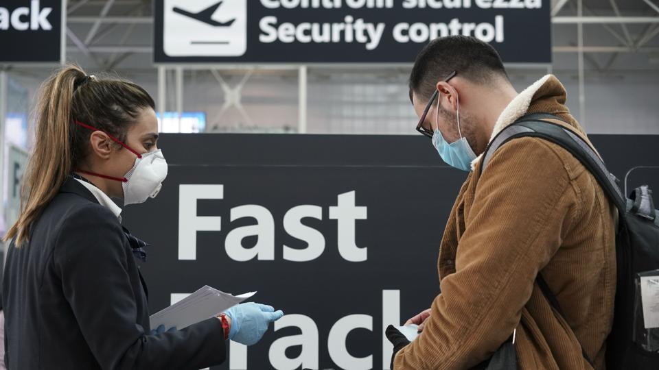 Ground staff gives information at the Rome Leonardo da Vinci international airport, Thursday, March 12, 2020. Italians woke up to yet further virus-containment restrictions after Premier Giuseppe Conte ordered restaurants, cafes and retail shops closed after imposing a nationwide lockdown on personal movement. For most people, the new coronavirus causes only mild or moderate symptoms, such as fever and cough. For some, especially older adults and people with existing health problems, it can cause more severe illness, including pneumonia. (AP Photo/Andrew Medichini) Ground staff gives information at the Rome Leonardo da Vinci international airport, Thursday, March 12, 2020. Italians woke up to yet further virus-containment restrictions after Premier Giuseppe Conte ordered restaurants, cafes and retail shops closed after imposing a nationwide lockdown on personal movement. For most people, the new coronavirus causes only mild or moderate symptoms, such as fever and cough. For some, especially older adults and people with existing health problems, it can cause more severe illness, including pneumonia. (AP Photo/Andrew Medichini)