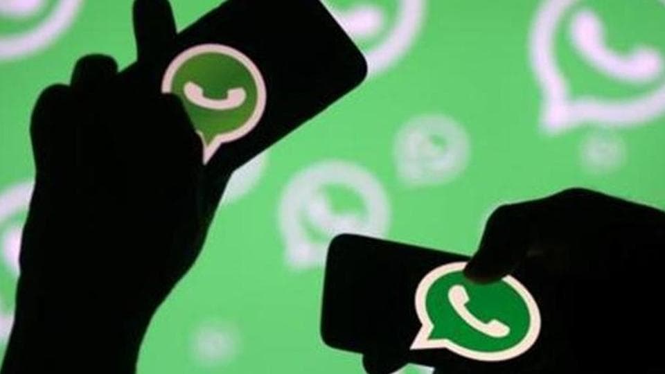 FILE PHOTO: Men pose with smartphones in front of displayed Whatsapp logo in this illustration September 14, 2017. REUTERS/Dado Ruvic