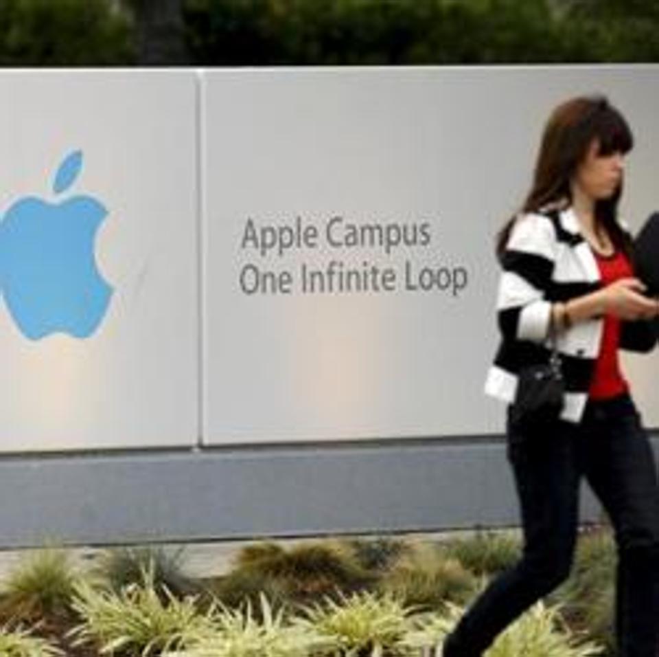 A woman enters Apple Inc.'s headquarters in Cupertino, California, U.S., on Thursday, Aug. 25, 2011. Apple Inc. Chief Executive Officer Steve Jobs, who transformed the company he started at age 21 from a personal-computer also-ran into the world's largest technology company, resigned Wednesday. Photographer: Noah Berger/Bloomberg