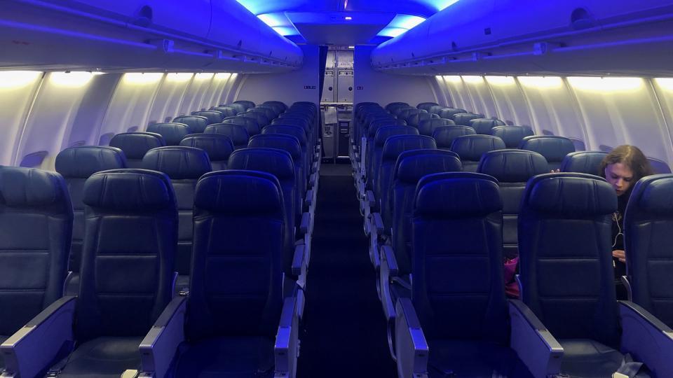 An air traveler sits among empty seats on a Delta flight to San Francisco, after further cases of coronavirus were confirmed in New York, at JFK International Airport, New York (representative image)