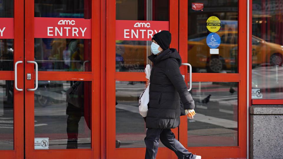 A person wears a protective mask while walking by an AMC movie theater as the coronavirus continues to spread across the United States on March 16, 2020 in New York City. The World Health Organization declared coronavirus (COVID-19) a global pandemic on March 11th.